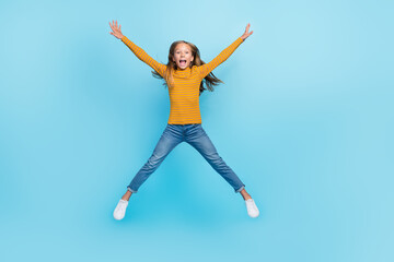 Full size photo of optimistic girl fluttering hairdo dressed yellow pullover denim pants flying...
