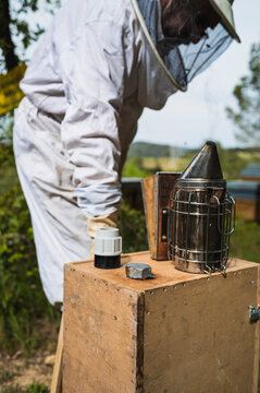 Focus selective of smoker with a beekeepers at work.
