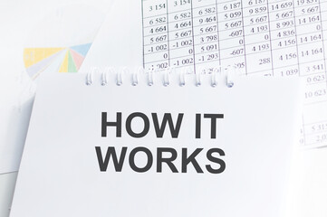how it works text on notepad on the background of charts and reports