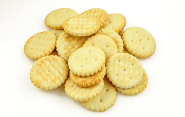 Pile of salty round crackers isolated on white background