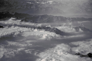 View of the tops of the mountains in the clouds from above