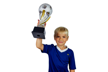 Young soccer player in blue jersey holds winners cup after the goal, isolated at light background