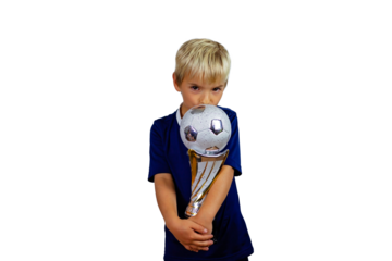 Young soccer player in blue jersey holds winners cup after the goal, isolated at light background