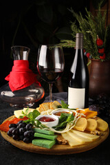 Cheese plate, wine, glasses. Cheeses, nuts, grapes, mint, sauces, honey snacks for red wine. Bar, menu, restaurant. Background image, copy space