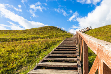 Fototapeta na wymiar Wooden stairs going up to the historical mound of Seredzius, Lithuania