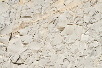 Exposure of light gray mudstone. Stone texture with cracks. Copy space.