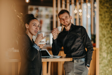 Businessman and businesswoman use modern devices, laptop, tablet and smartphone and arrange new projects for the job. 