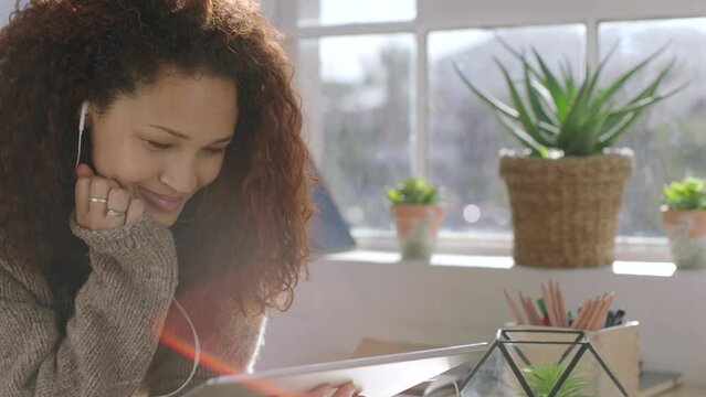 Learning, tablet and growth with a woman student watching an online video for learning and development in her home. Internet, technology and study with a female pupil listening to a remote class