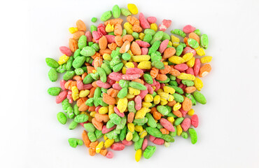 Colorful puffed rice sweets. Pile of rainbow drops cand isolated on white background