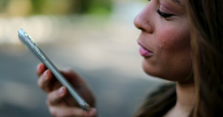 Person sending voice message on cellphone device, close-up mouth speaking