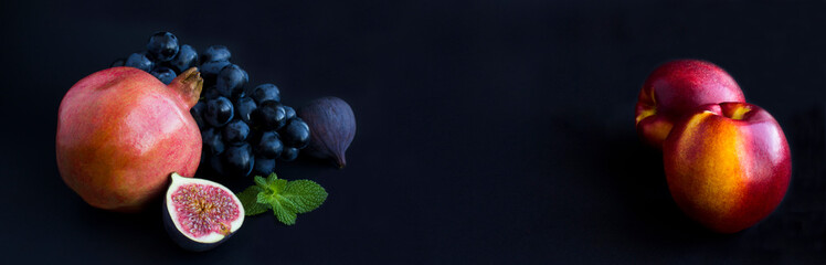 Banner. Fruit and berry on the black background. Copy space. Close-up.