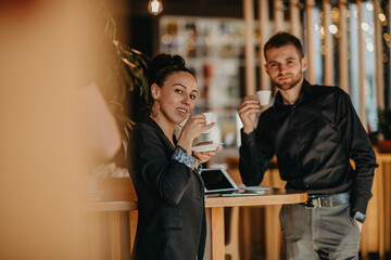 Businessman and businesswoman use modern devices, laptop, tablet and smartphone and arrange new projects for the job. 