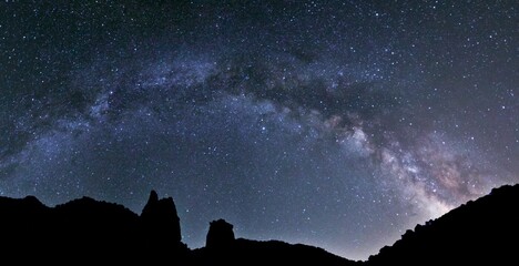 Silhouette of mountains under blissful Milky Way in the sky