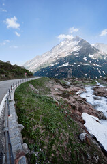 Fototapeta na wymiar Travel by Switzerland. Beautiful summer Alpine mountains landscape with snow.