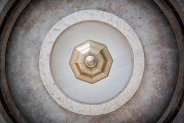 3D rendering of a background texture, with a marble pattern and golden geometric shape in the center