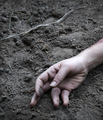 Hand of a wounded soldier covered in blood