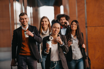 Travelers business team of colleagues walking and talking on modern urban city streets. People on out of the office on break. 