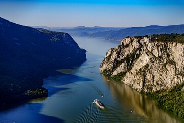 Aerial view of boat in Iron Gates gorge on the river Danube in Romania - obrazy, fototapety, plakaty