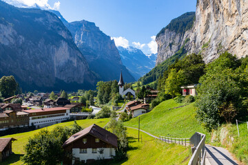 View of Lauterbrunnen Swiss town with Staubbach waterfall on its side. This village is one of the...