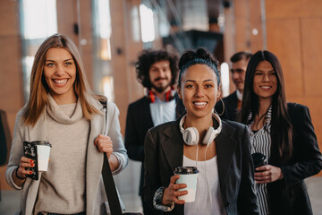 Travelers business team of colleagues walking and talking on modern urban city streets. People on out of the office on break. 