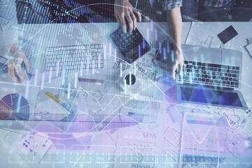 Multi exposure of man and woman working together and financial chart hologram. Business concept....