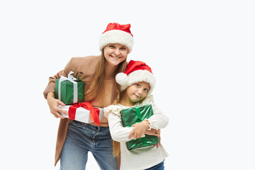 Christmas family. Cute young mother and daughter in santa Claus caps holding colorful gift boxes on white. Preparing for New Year's holidays in Italy