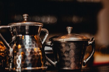 Close up of a silver teapot and a sugar bowl