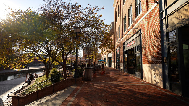 Frederick, MD, USA - 11 10 2021: Carroll Creek Park in historic district of Frederick with shops and building on sides of the canal.