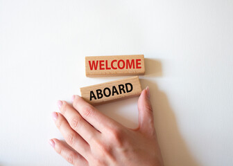 Welcome aboard symbol. Concept word Welcome aboard on wooden blocks. Beautiful white background. Businessman hand. Business and Welcome aboard concept. Copy space