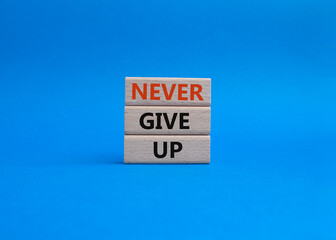 Never give up symbol. Concept words Never give up on wooden blocks. Beautiful blue background. Business and Never give up concept. Copy space.