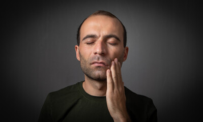 Caucasian man suffering from tooth pain.
