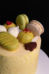 Cake decor, decoration, closeup. Black Forest cake with white chocolate, and macaroons. ornaments and decoration on cake, sponge cake with a rich cherry filling, german dessert.