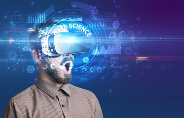 Businessman looking through VR glasses