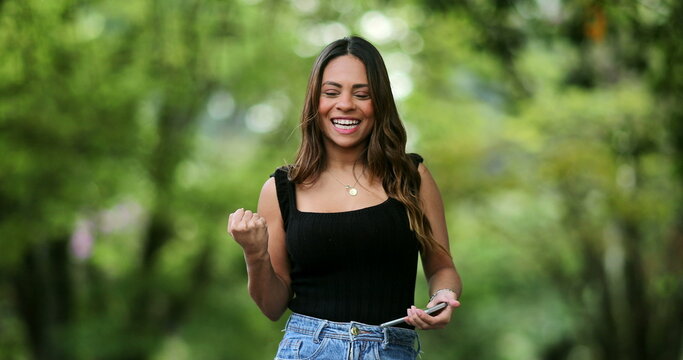 Pretty Girl Happy With Message On Phone Jumping With Joy