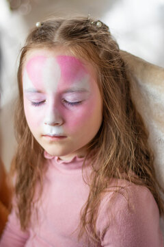 selective focus. A makeup artist works. childrens makeup face paint drawings Girls face painting. Little girl having face painted on birthday party. closed eyes. aqua make-up