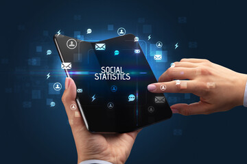 Businessman holding a foldable smartphone, social media concept