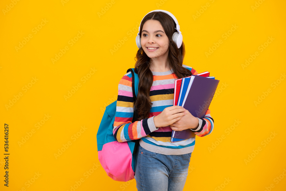 Canvas Prints school girl, teenage student in headphones and books on isolated studio background. school kids with