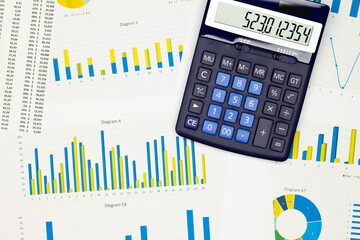 Top view office table desk. Financial report. Flat lay. Workspace with Business office supplies, Accounts number on the data paper, diagrams, calculator. Copy space for text. Top view