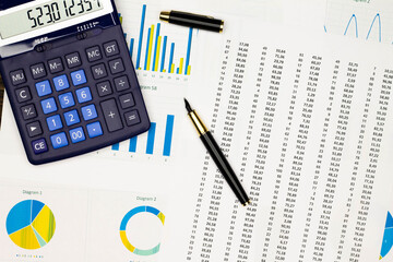 Naklejka na ściany i meble Top view office table desk. Financial report. Flat lay. Workspace with Business office supplies, Accounts number on the data paper, diagrams, pen, calculator. Copy space for text. Top view
