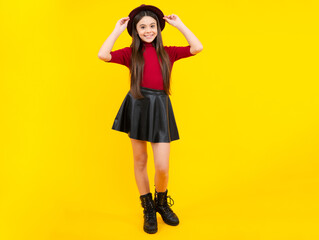 Full length of attractive cheerful teenager child girl in casual fashion clothes over yellow...