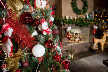 Magic glowing tree. Christmas home interior with Christmas tree. Red and white balls hanging on pine branches. Festive lights in the brick wall background. New Year concept.