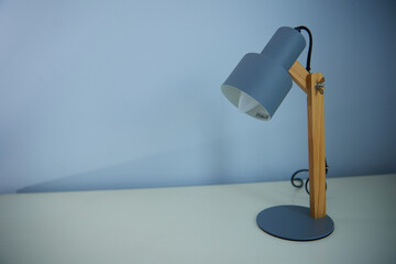 An office desk lamp illuminating the background. Lots of copy space.
