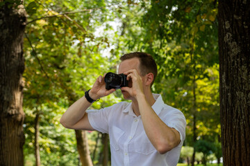 Fototapeta premium A young man walks and photographs nature