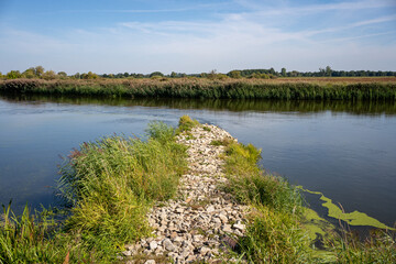 rocky non-submerged river spur dike at the Warta river near Osiecza I in Greater Poland Province, Poland