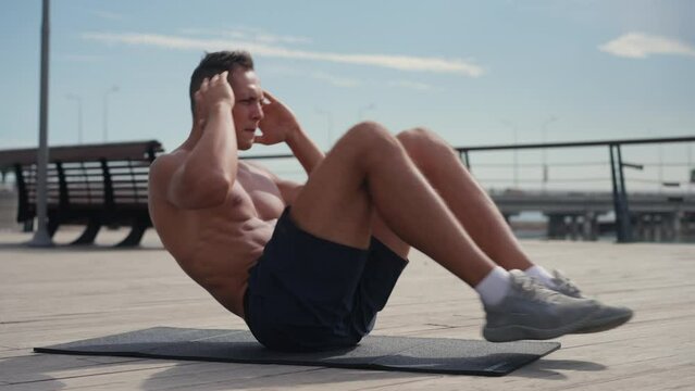sport, fitness and healthy lifestyle concept - Caucasian man making abdominal exercises at home. Core training at home