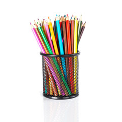 Colorful pencils in a black basket over a white background