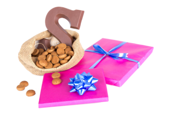 Jute bag with chocolate, ginger nuts and presents; a Dutch tradition at Sinterklaas event in december isolated on transparent background