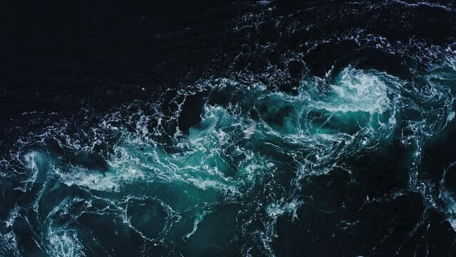 4K drone video with birds-eye view of the abstract and powerful water currents, rapids and whirlpools of the worlds larges maelstrom Saltstraumen
