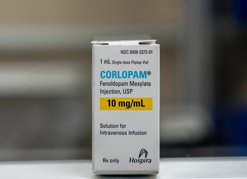 Close-up view of a box of Corlopam 10mg over the white surface