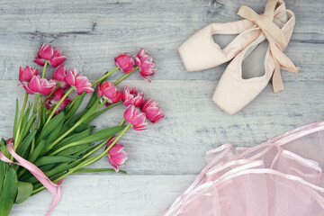 ballet pointe shoes, pink tutu skirt and tulip flowers